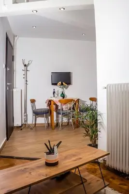 a living room with a table and a dining room at Cozy Athens Hideaway in Athens