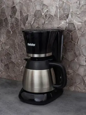 a black and silver coffee maker sitting on a counter at Cozy Athens Hideaway in Athens
