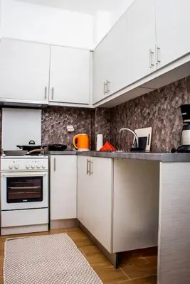 a kitchen with white cabinets and a sink at Cozy Athens Hideaway in Athens