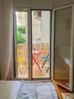 a room with a sliding glass door to a patio with a table at Cozy Athens Hideaway in Athens