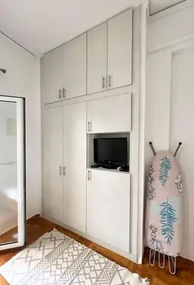 a living room with white cabinets and a television at Cozy Athens Hideaway in Athens