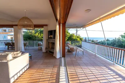 a balcony of a house with a view of the ocean at Villa Antiope Saronida in Saronida
