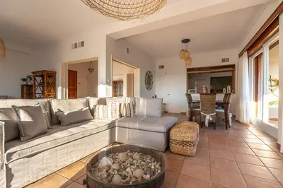 a living room with a couch and a table at Villa Antiope Saronida in Saronida
