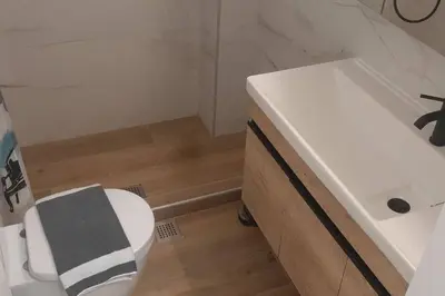 a bathroom with a white sink and a toilet at Το σπίτι του καπετάνιου στη Βουλιαγμένη in Athens