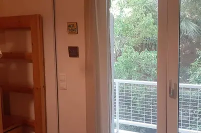 a room with a window and a door with a view at Το σπίτι του καπετάνιου στη Βουλιαγμένη in Athens