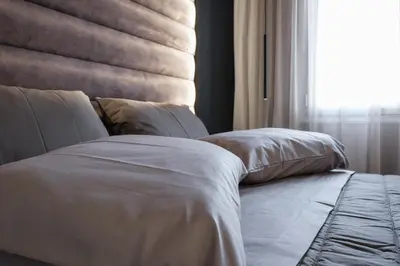 a bed with white sheets and pillows next to a window at Golden Island Resorts in Athens