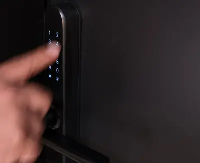 a hand is holding a black remote control at Golden Island Resorts in Athens