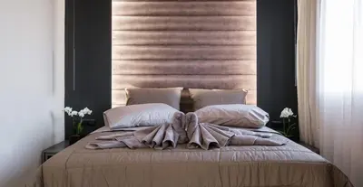 a bedroom with a bed with a blanket and pillows at Golden Island Resorts in Athens