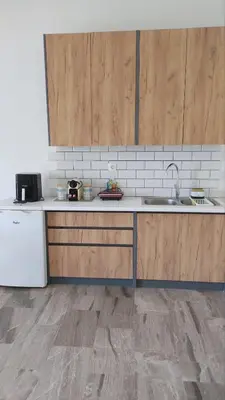 a kitchen with wooden cabinets and a sink at Euphoria Estate in Agia Marina Aegina