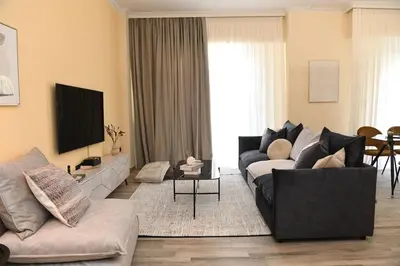 a living room with a couch and a tv at Konstantina Apartment in Athens
