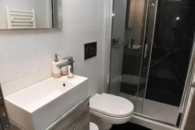 a bathroom with a sink and a shower and a toilet at Konstantina Apartment in Athens