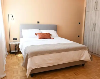 a bedroom with a large bed with a teddy bear on it at Alkmini Apartment in Athens