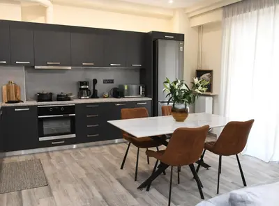 a kitchen with a table and chairs in a kitchen at Alkmini Apartment in Athens