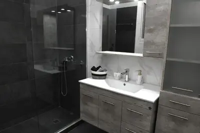 a bathroom with a sink and a shower at Alkmini Apartment in Athens