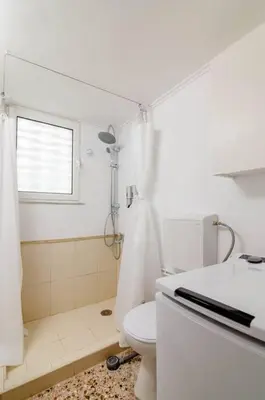 a white bathroom with a toilet and a sink at Athens Paradise Apartament 50 sqm Near To Metro #2 in Athens