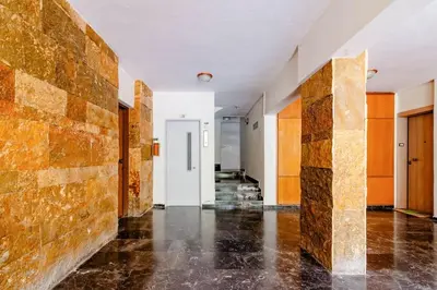 an empty room with a brick wall and a hallway at Athens Paradise Apartament 50 sqm Near To Metro #2 in Athens