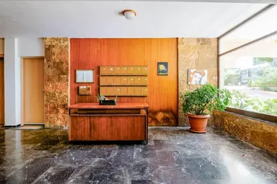 a room with a desk and a plant in it at Athens Paradise Apartament 50 sqm Near To Metro #2 in Athens