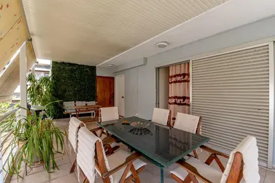 a dining room with a glass table and chairs at Evie's cozy apartment in Athens