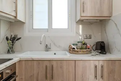 a kitchen with a sink and a window at Amazing sea view apartment in Lagonissi in Kalívia Thorikoú