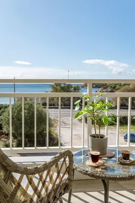 a balcony with a table and a potted plant at Amazing sea view apartment in Lagonissi in Kalívia Thorikoú