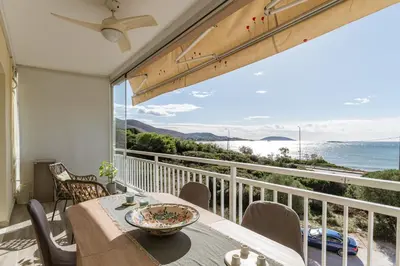 a dining room with a view of the ocean at Amazing sea view apartment in Lagonissi in Kalívia Thorikoú