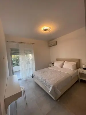 a bedroom with a large bed and a window at Daniel's House - Palaia Fokaia in Palaiá Fókaia