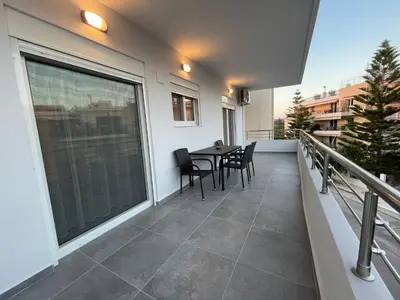 a balcony with a table and chairs on it at Daniel's House - Palaia Fokaia in Palaiá Fókaia