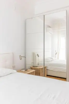 a white bedroom with a mirror and a bed at 3 bedroom New Modern Flat in the heart of Athens in Athens
