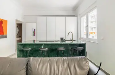 a kitchen with a green island with stools at 3 bedroom New Modern Flat in the heart of Athens in Athens