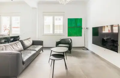 a living room with a couch and a table at 3 bedroom New Modern Flat in the heart of Athens in Athens