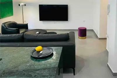 a living room with a couch and a table at 3 bedroom New Modern Flat in the heart of Athens in Athens
