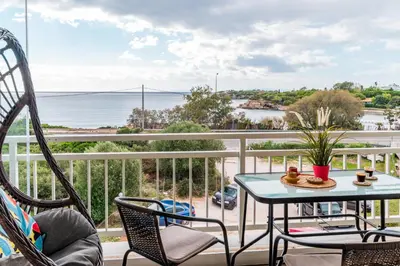 a balcony with a table and chairs and the ocean at Fantastic sea view one-bedroom apartment - Lagonissi in Lagonissi