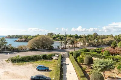 a street with cars parked on the side of a road at Fantastic sea view one-bedroom apartment - Lagonissi in Lagonissi