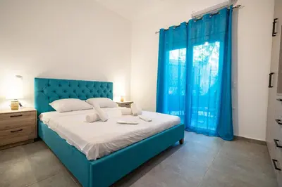 a bedroom with a blue bed and a window at Koukaki 1 bedroom 4 persons apartment by MPS in Athens