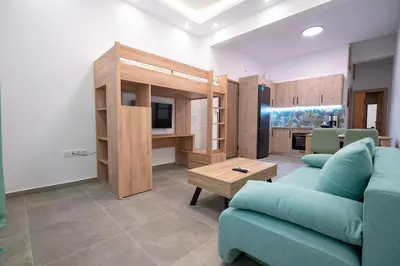 a living room with a blue couch and a tv at Koukaki 1 bedroom 4 persons apartment by MPS in Athens
