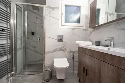 a bathroom with a shower and a toilet and a sink at Koukaki 1 bedroom 4 persons apartment by MPS in Athens