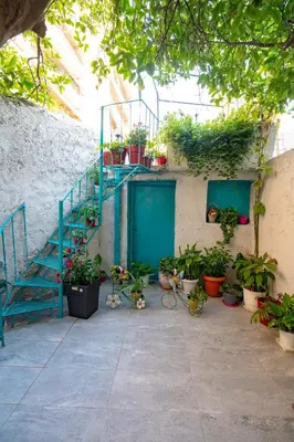 a patio with a blue door and potted plants at Koukaki 1 bedroom 4 persons apartment by MPS in Athens