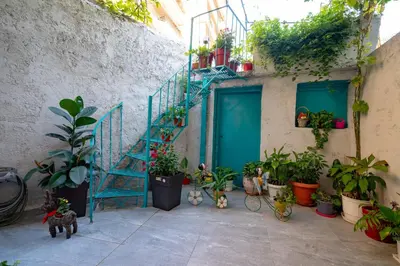 a blue staircase in a courtyard with potted plants at Koukaki 1 bedroom 4 persons apartment by MPS in Athens