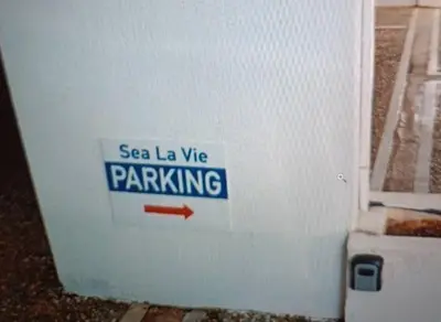 a sign on the side of a refrigerator with a red arrow at Sea, La Vie in Saronida