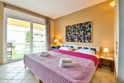 a bedroom with a bed with two towels on it at Beachside Bungalows in Athens