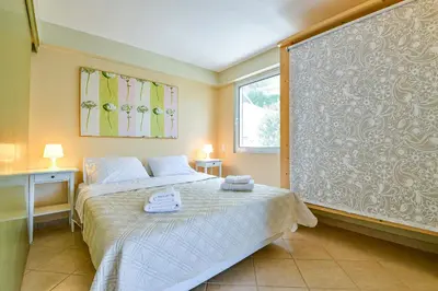 a bedroom with a bed and a large wall at Beachside Bungalows in Athens