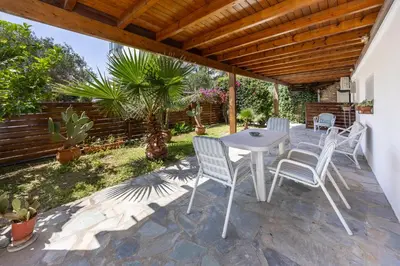 a white table and chairs on a patio at Beachside Bungalows in Athens