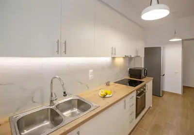 a kitchen with a sink and a counter top at Beautiful apt near the sea by GHH in Athens