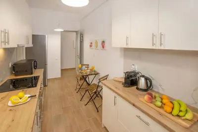 a kitchen with a counter with fruit on a cutting board at Beautiful apt near the sea by GHH in Athens