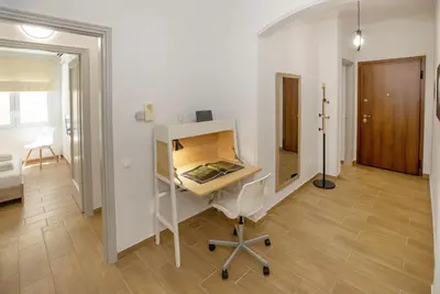 a room with a desk and a chair in a room at Beautiful apt near the sea by GHH in Athens