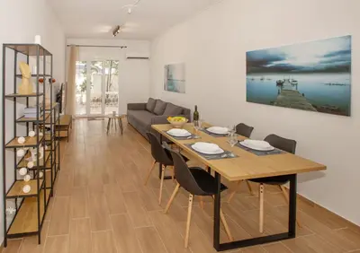 a living room with a table and a couch at Beautiful apt near the sea by GHH in Athens