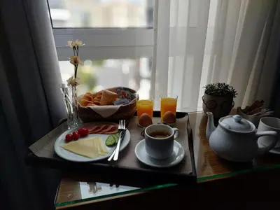 a breakfast tray with breakfast foods and coffee on a table at Lacoba Hotel in Athens