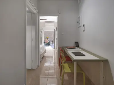 a kitchen with a counter and a table in a room at AnapironPolemou5-Eleutheriou in Athens