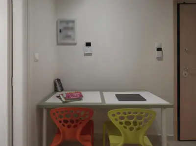 a table with two chairs in a room at AnapironPolemou5-Eleutheriou in Athens