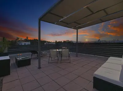 a patio with a table and chairs at sunset at Iliodorou2-4 in Athens